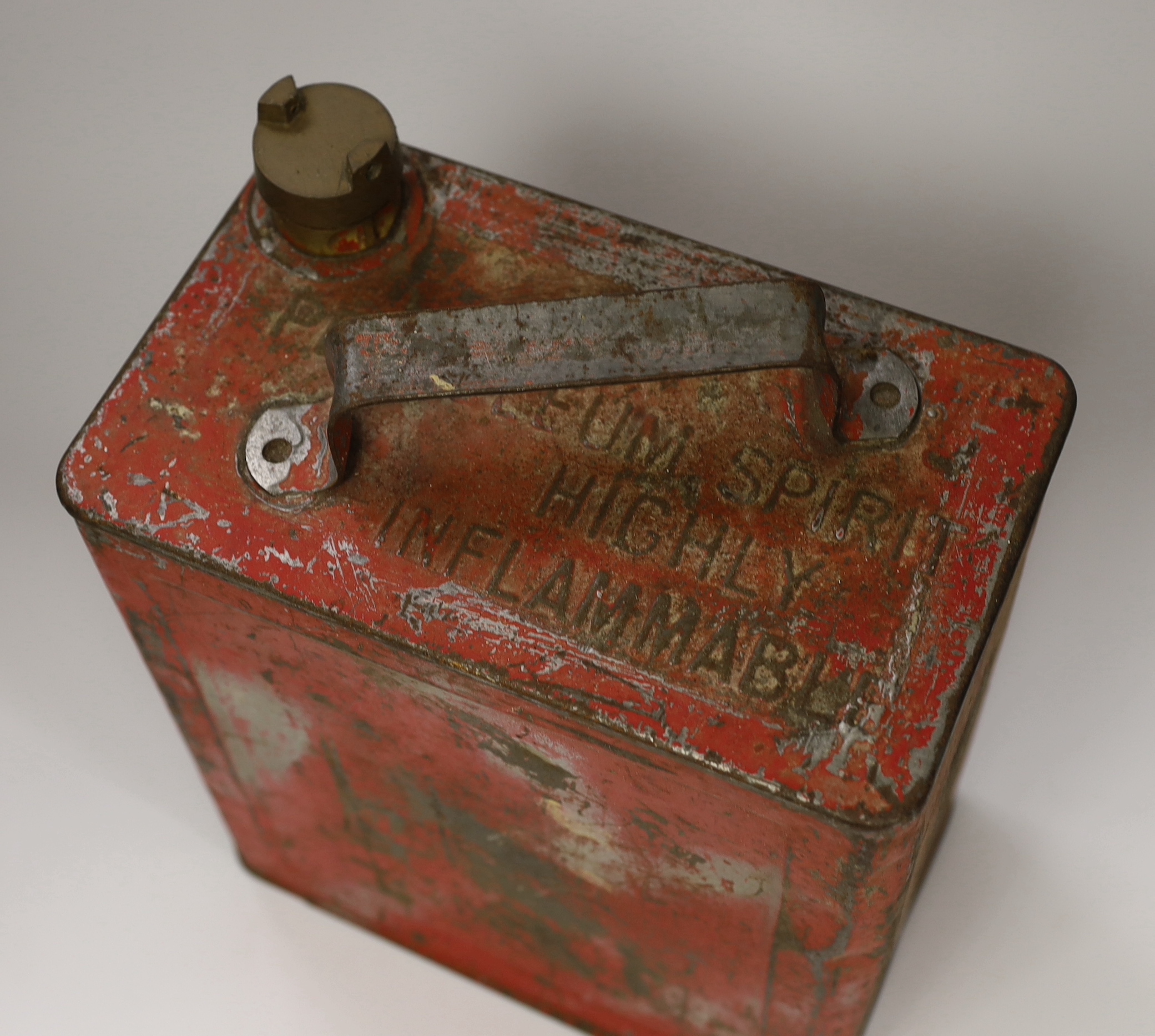 A 20th century red petrol can and two others, largest 32cm high